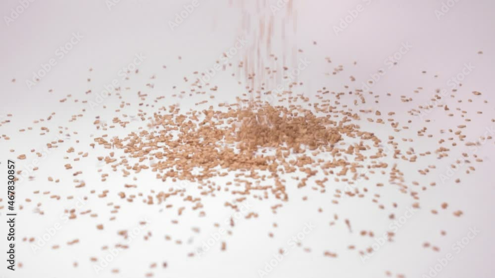 Heap Of Sesame Seeds Dropping In White Background. close up Heap Of Sesame Seeds Dropping In White Background. close up