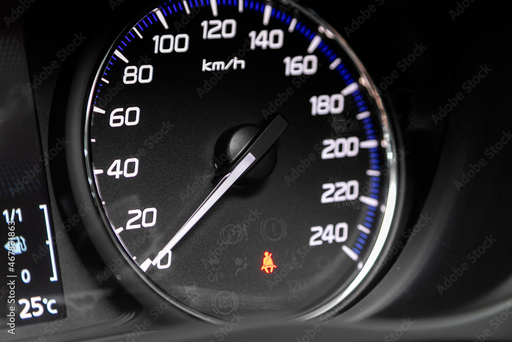 Close up picture of a cars speedometer.