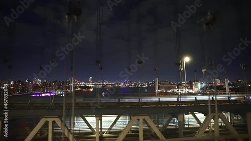Night New York City Manhattan seen from bridge. NYC is American tourism destination, iconic landmark travel in USA. 4k slow motion. 