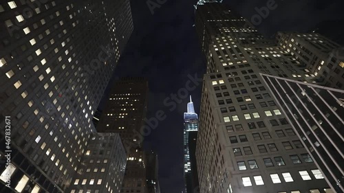 New York City at night, Manhattan business skyscrapers. low angle glide moving tracking shot. American modern urban city. NYC tourism destination in USA. 