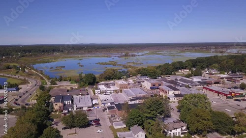 Panning aerial of town of Whitehall, Michigan and water on sunny day photo