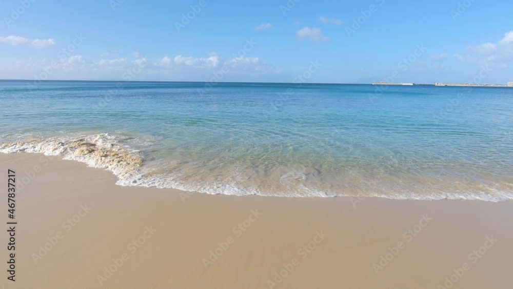 The beach and small waves next to naval base The beach and small waves next to naval base