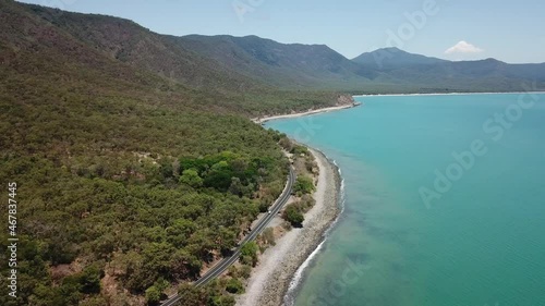 Drone aerial going lower and parallax over tropical blue water and beach photo