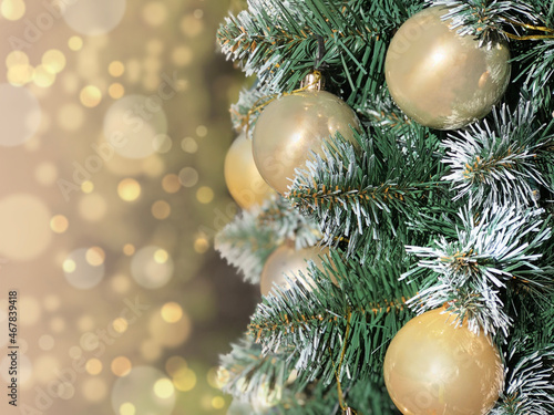 Christmas background with pine branches and golden balls.