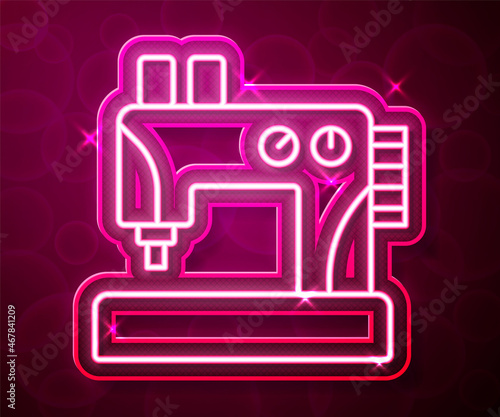 Glowing neon line Sewing machine icon isolated on red background. Vector