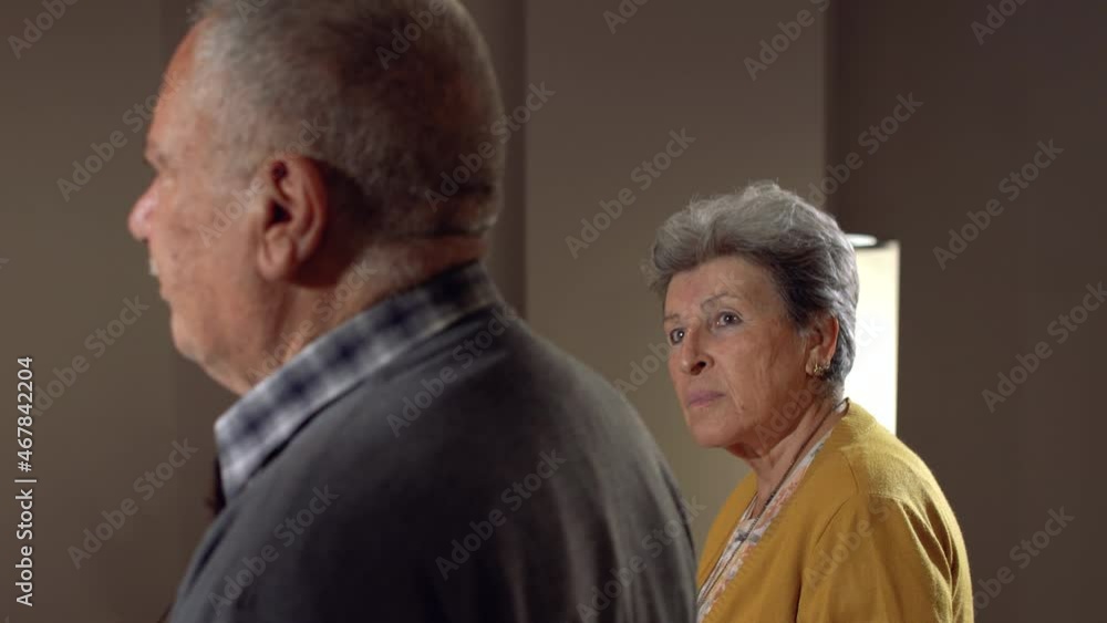 The old woman is looking at her husband. Elderly couple looking to the future with hope. The old woman is looking at her husband. Elderly couple looking to the future with hope.