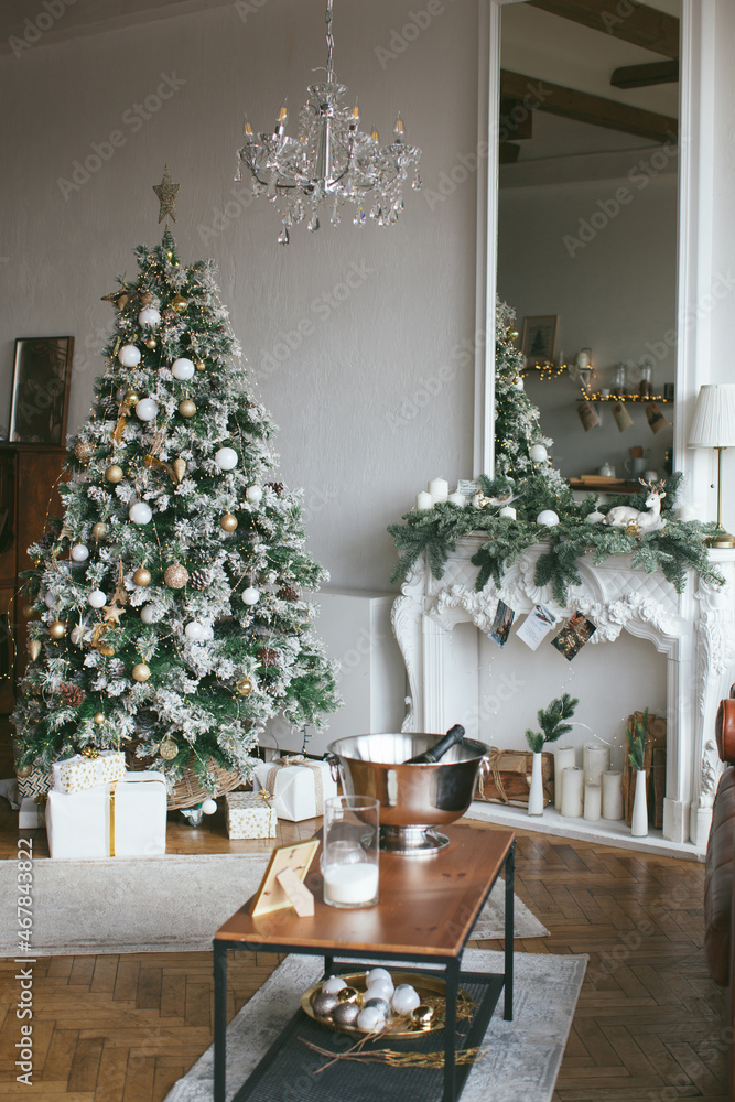 Christmas interior in retro style. White fireplace and mirror with christmas tree garland.