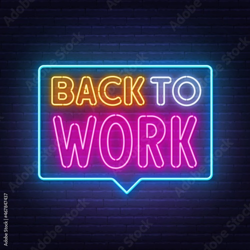 Back to Work neon lettering on brick wall background.