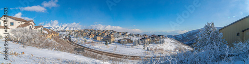 View of different houses in a snowy residential area at Draper, Utah with Wasatch Mountains' view © Jason