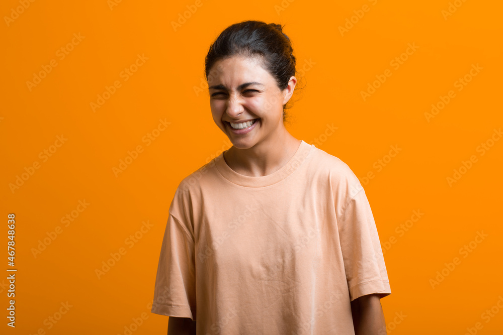 Portrait of young adult positive smiling indian woman in T-shirt Portrait of young adult positive smiling indian woman in T-shirt