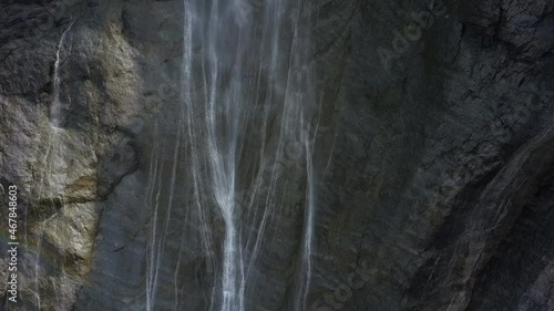 Aerial view of the Gavarnie falls with water cascading down the cliffs and rocks taken from above at the highest waterfalls in mainland France at the Cirque Of Gavarnie, Hautes Pyrenees, France.