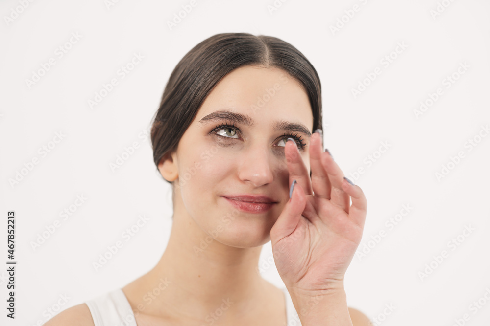 The girl cries with happiness and wipes tears from her cheeks with her hand. Tears of happiness. The girl cries with happiness and wipes tears from her cheeks with her hand. Tears of happiness.
