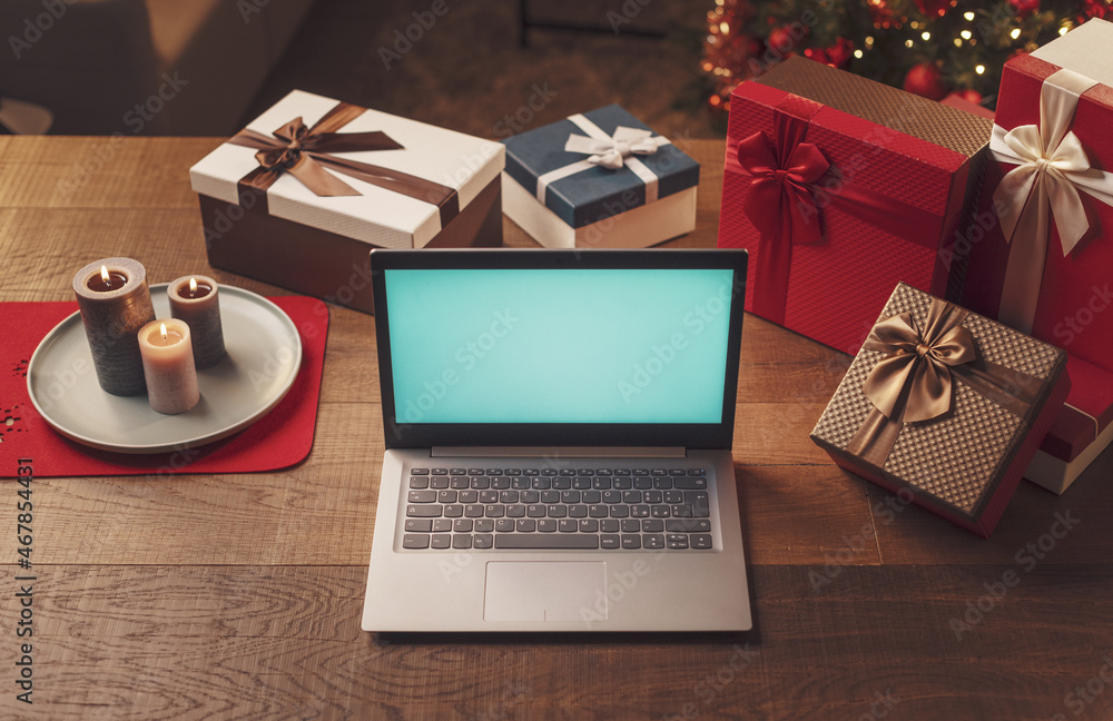 Laptop with blank screen and Christmas gifts Laptop with blank screen and Christmas gifts