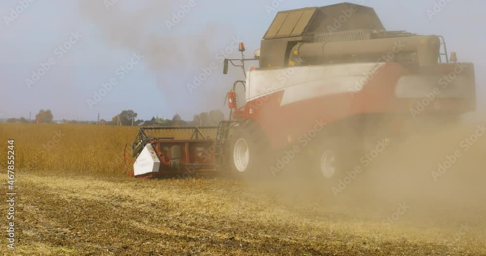Combine Harvester Working on a Field, Slow motion. Seasonal Harvesting the Wheat, Soy. Agriculture. Farm. Crop. Agrarian business. Industry Combine Harvester Working on a Field, Slow motion. Seasonal Harvesting the Wheat, Soy. Agriculture. Farm. Crop. Agrarian business. Industry