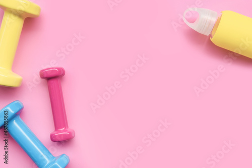 close up of dumbbell on pink background