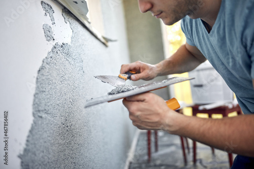 Quadro su tela Man working on a house facade.