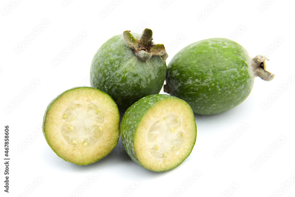 Feijoa fruit or whole and half pineapple guava isolated on white Feijoa fruit or whole and half pineapple guava isolated on white
