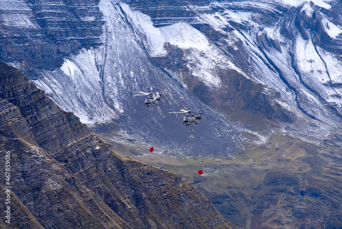 Two super Puma AS532 Cougar helicopters register T-340 with water filled containers at Axalp Air Show. Photo taken October 19th, 2021, Axalp, Switzerland. photo