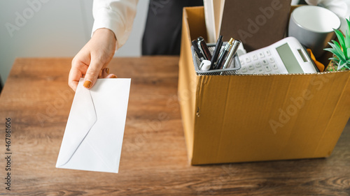 Quadro em tela Business woman sending resignation letter and packing Stuff Resign Depress or carrying business cardboard box by desk in office