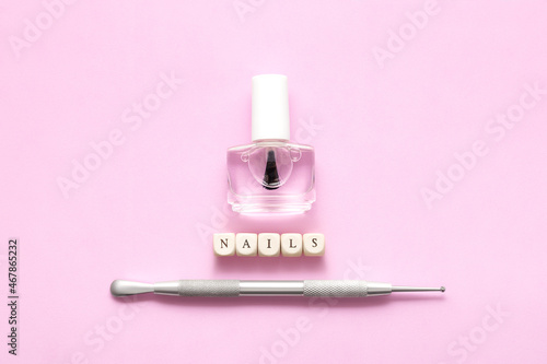 Top view on manicure equipment set. Female nails care equipment. Manicure and pedicure equipment on pink background. Copy space.
