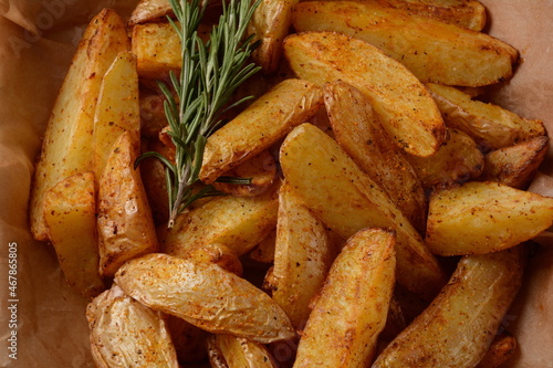 Baked, fried  potato  wedges with spices and rosemary