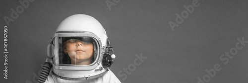 the child studies remotely at school, wearing an astronaut's helmet. back to school © vovan