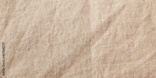 Banner beige textile linen tablecloth in full frame. Cloth texture background. Copy space. photo