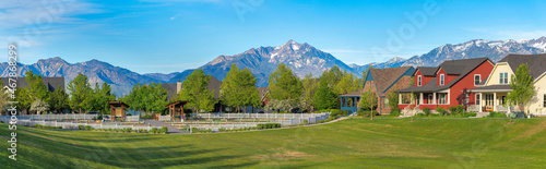 Panoramic view of a large field at the front of residential houses at Daybreak, Utah