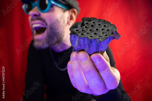 Dried lotus flower in the hands of a man. Representation of trypophobia