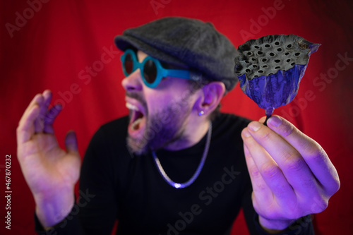 Dried lotus flower in the hands of a man. Representation of trypophobia