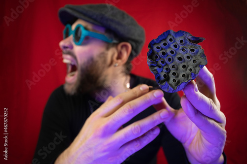 Dried lotus flower in the hands of a man. Representation of trypophobia