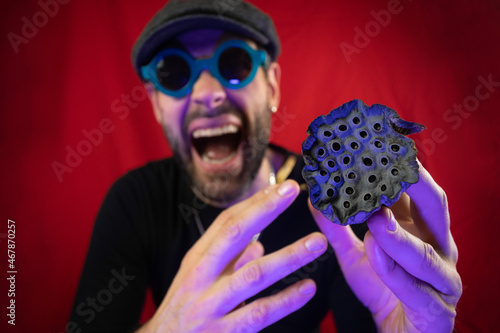 Dried lotus flower in the hands of a man. Representation of trypophobia