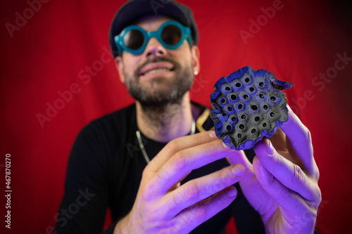 Dried lotus flower in the hands of a man. Representation of trypophobia