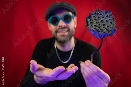 Dried lotus flower in the hands of a man. Representation of trypophobia