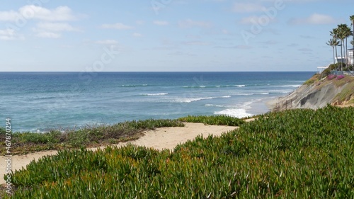 Seascape vista point, viewpoint in Carlsbad, California coast USA. Frome above panoramic ocean tide, blue sea waves, steep eroded cliff. Coastline shoreline overlook. Green ice plant succulent lawn.