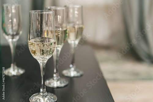 Close-up of champagne glasses in a row on the table. Copy space.