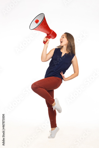 Cheerful woman with loudspe...