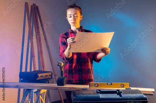 woman is doing home repairs...