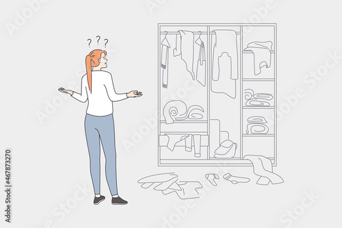 Difficult choice and wardrobe concept. Young frustrated woman cartoon character standing looking at chaos in wardrobe trying to choose clothes vector illustration 