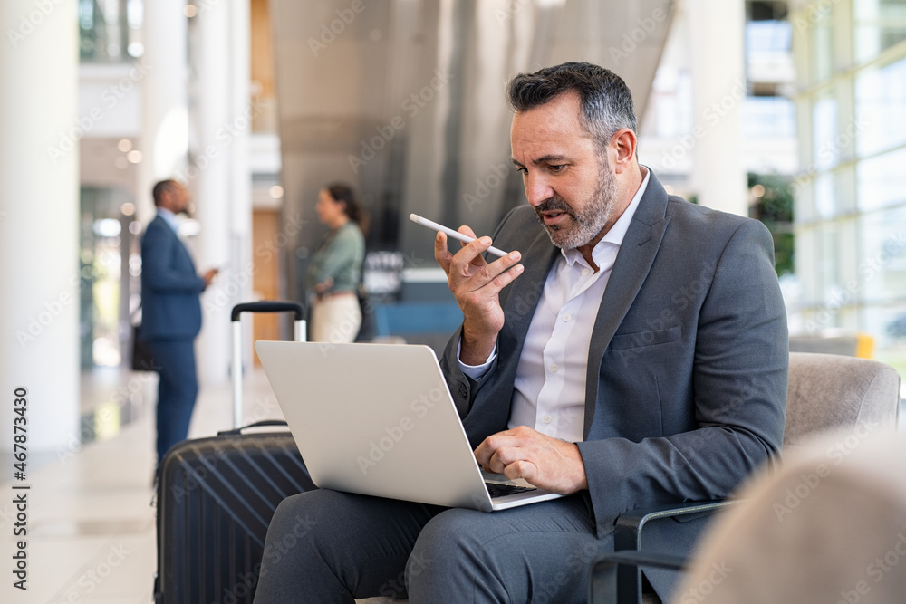 Businessman working with phone and laptop at the airport Businessman working with phone and laptop at the airport