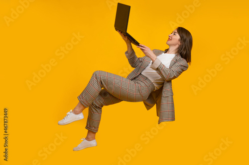 Woman with laptop in zero v...
