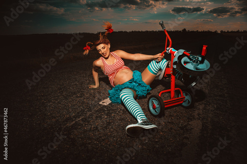 Pregnant Pippi Longstocking are falling downe during the walk in summer nature photo