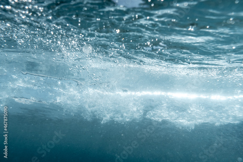 Underwater View of Bubbles In Deep Blue Ocean. Close Up Water. Background
