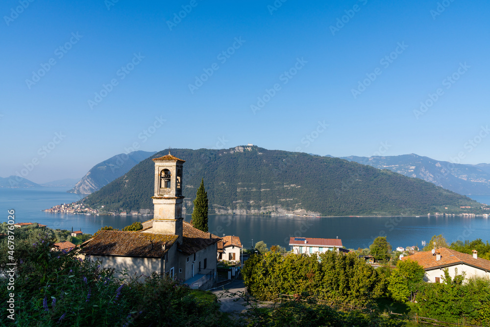 Fototapeta premium view of the Iseo Lake in northern Italy with an old mountain village and hcurch i nthe foreground