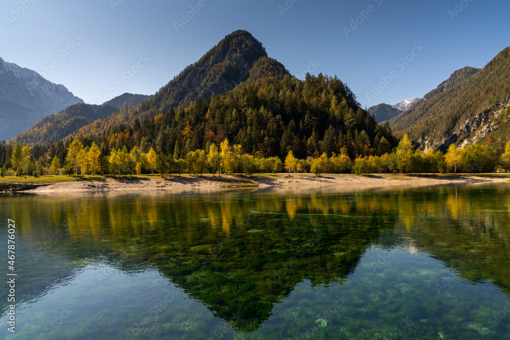 Fototapeta premium view of Lake Jasna with forest and mountain landscape in beautiful autumn colors