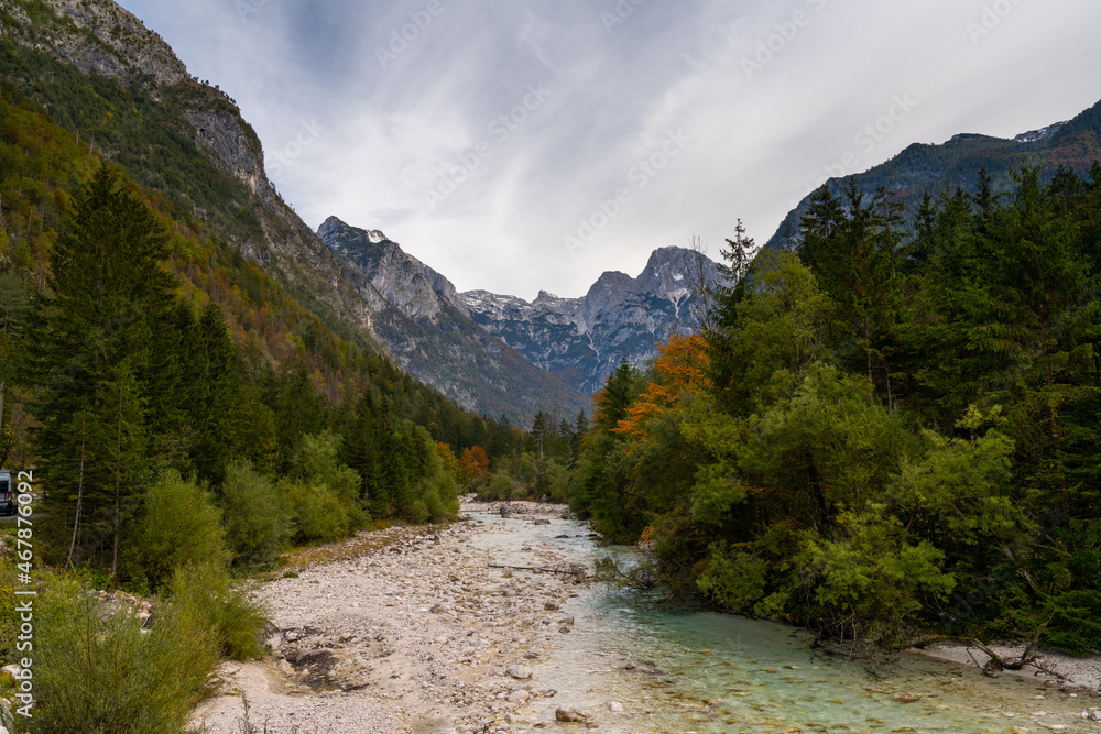 landscape in Triglav National Park in late autumn with colorful foliage and the Soca River in the foreground