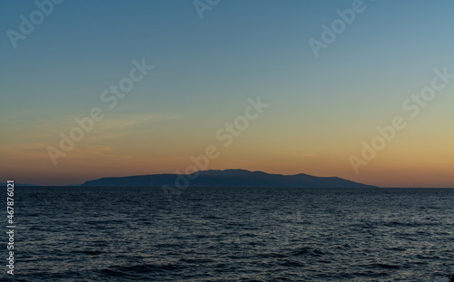 view of the Bay of Kvarna with the silhouette of Cres Island at sunset