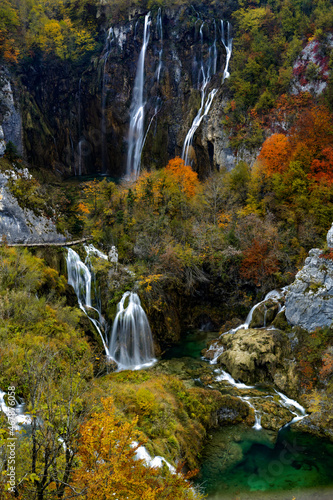 vertical view of the great waterfalls in Plitivice with vibrant and colorful fall color foliage photo