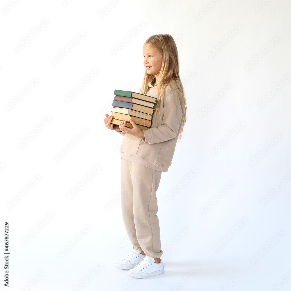 Beautiful girl holds a large stack of books Beautiful girl holds a large stack of books