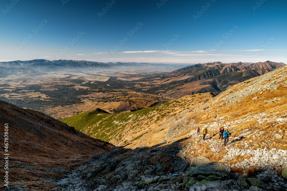 Touristts hiking on mountain trail to peak Krivan in High Tatras mountains, Slovakia